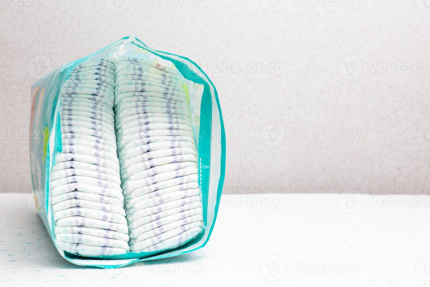 A whole package of baby diapers on a white background. Copy space for text photo