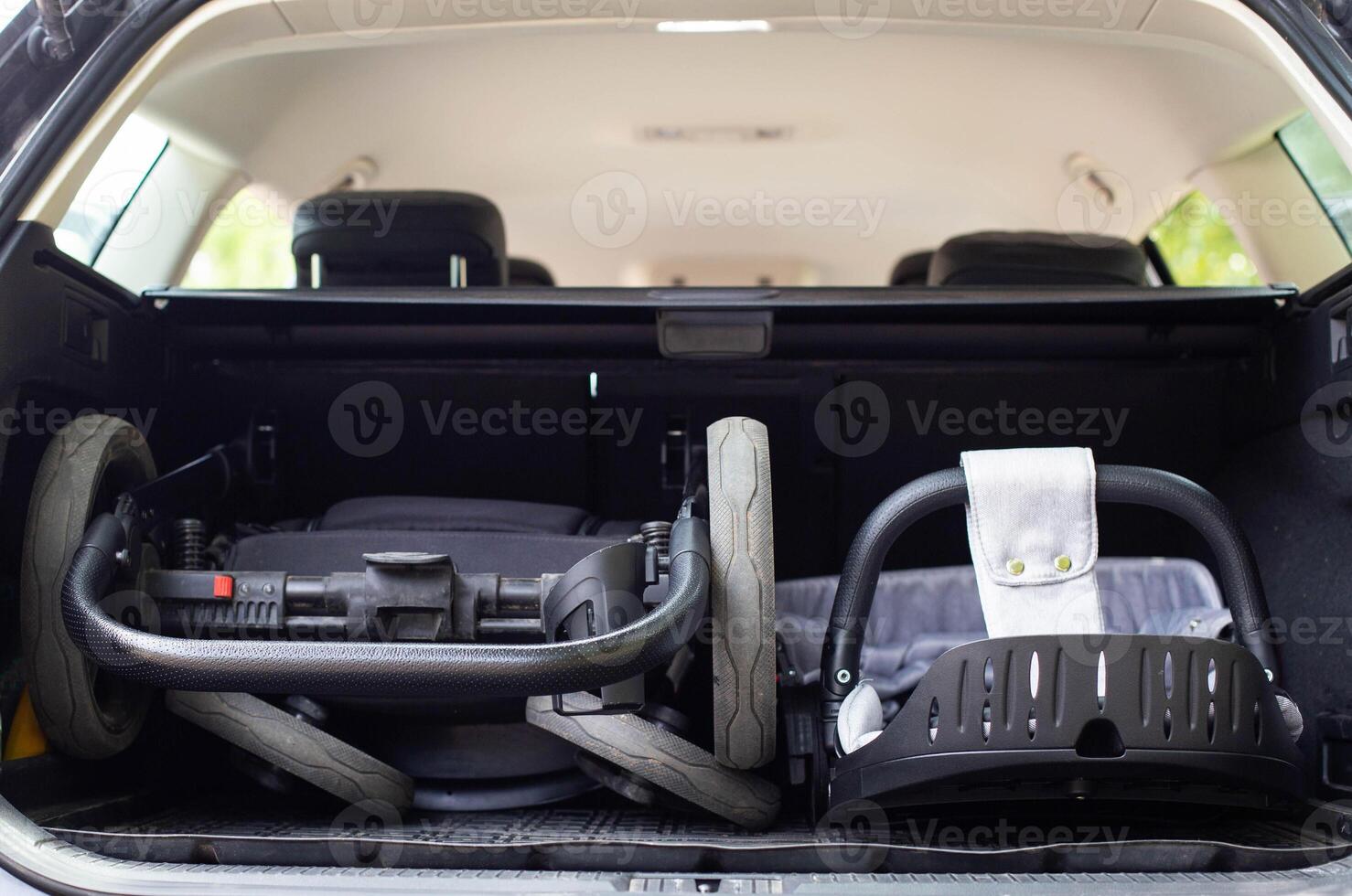 transporting a baby stroller in the trunk of a car when folded, close-up photo