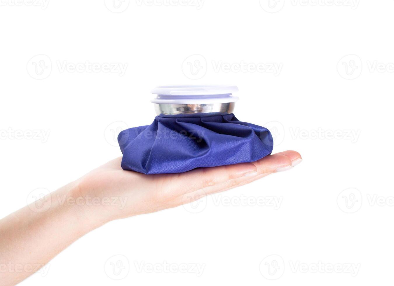 Blue medical ice bag on the palm, white background, isolate. Concept cold bag for pain relief, close-up photo