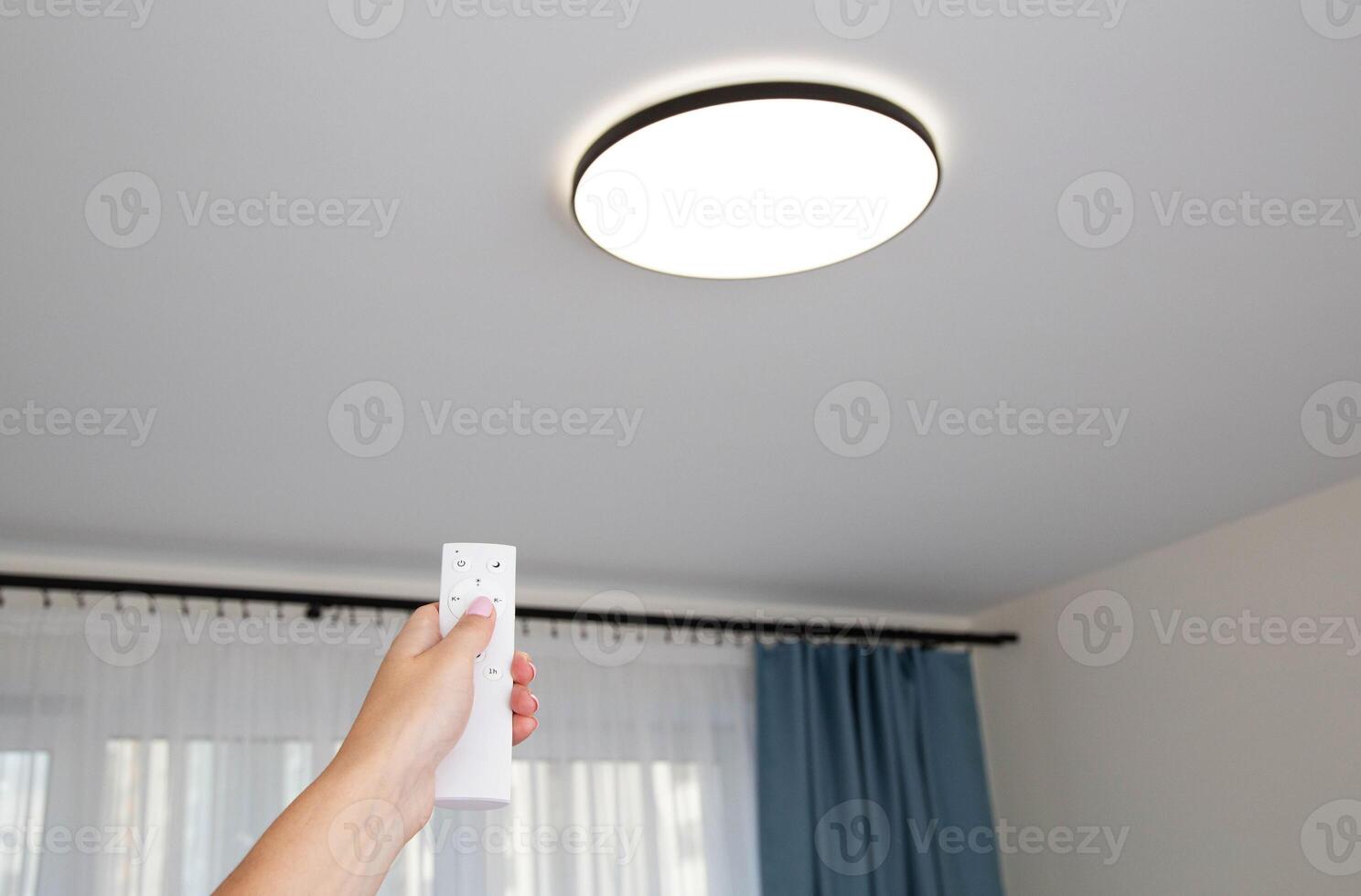 Modern LED ceiling chandelier with on off control panel. Adjusting the brightness of the lighting in the room, technologies. Sleep timer photo