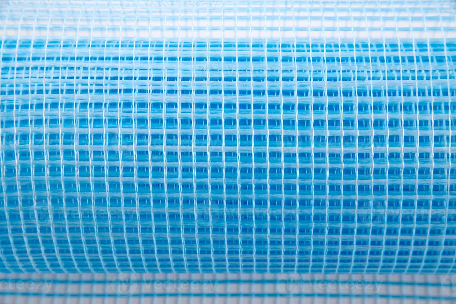 Blue reinforcing construction mesh for wall strengthening on white background, isolate. Close-up photo
