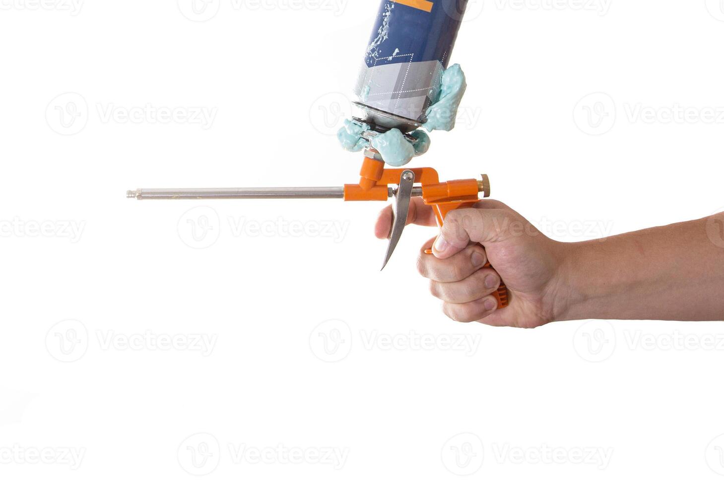 Man in hand holds a gun for a cylinder with polyurethane foam with a defect on a white background, isolate. Close-up photo