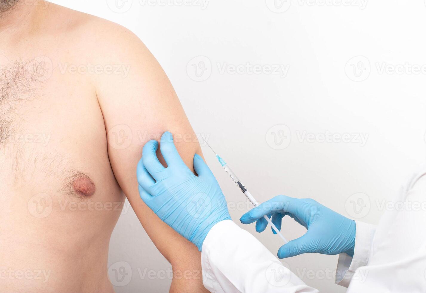 A doctor gives an injection into a man's forearm to increase the muscle mass of the biceps and triceps. Muscle Strength Injection Drugs Concept. Copy space for text, anatomical photo
