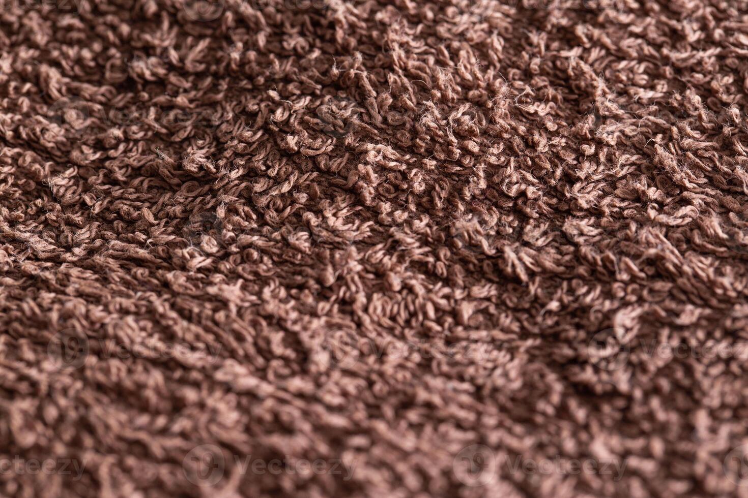 Brown terry towel, background, close-up. handicrafts photo
