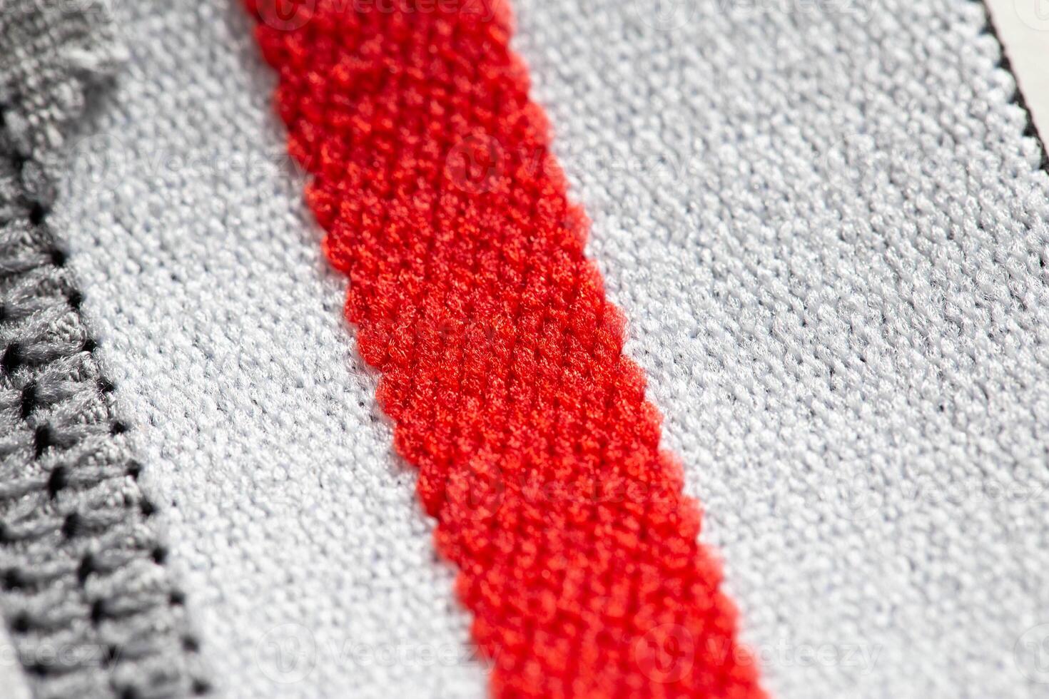 Fabric with white and red stripes, background. Macro, texture photo