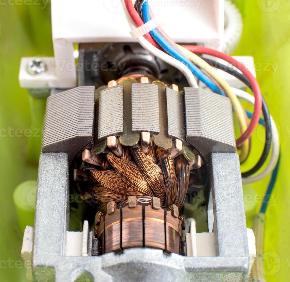 Broken electric motor in a household appliance hand mixer. Malfunction of the rotor and stator of electrical components, close-up photo