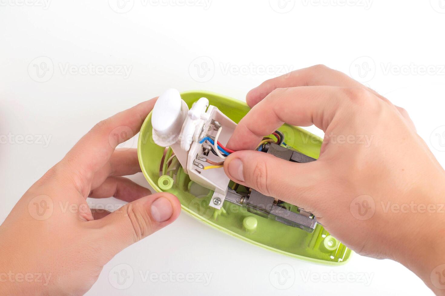 A man repairs a broken kitchen mixer, close-up. Concept for the provision of services for the repair of household appliances, hobby photo