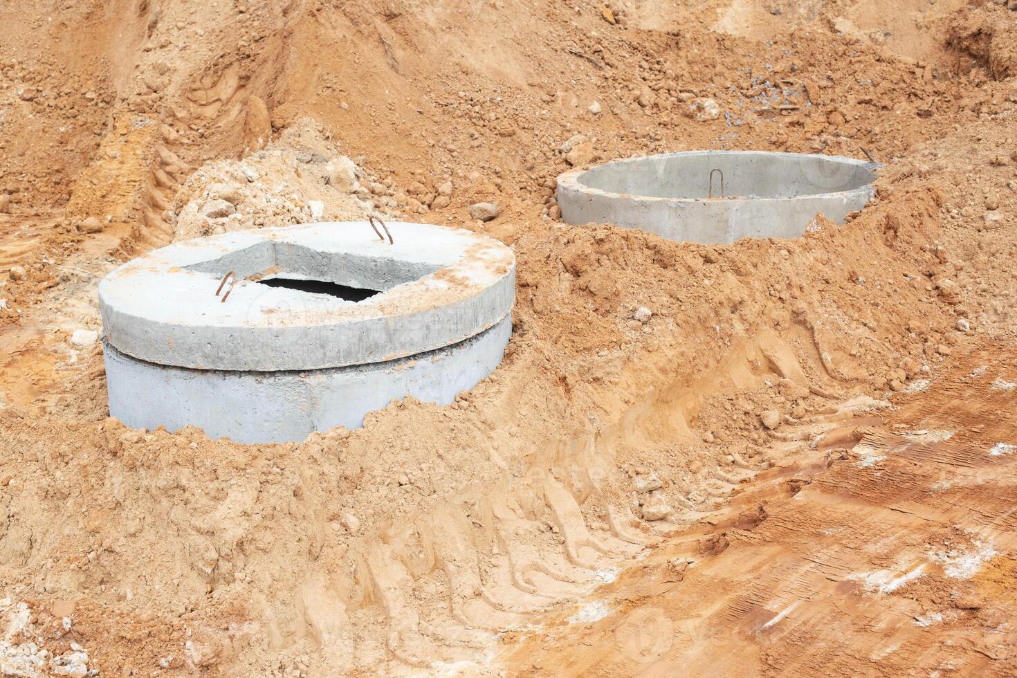 Construction of a sewage system for draining sewage from the road using reinforced concrete rings photo
