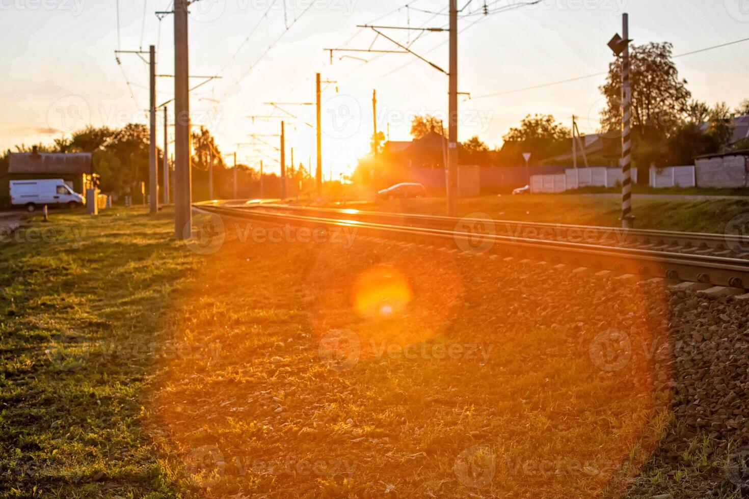 railway and railway crossing on the background of a sunny sunset, background. Copy space for text photo