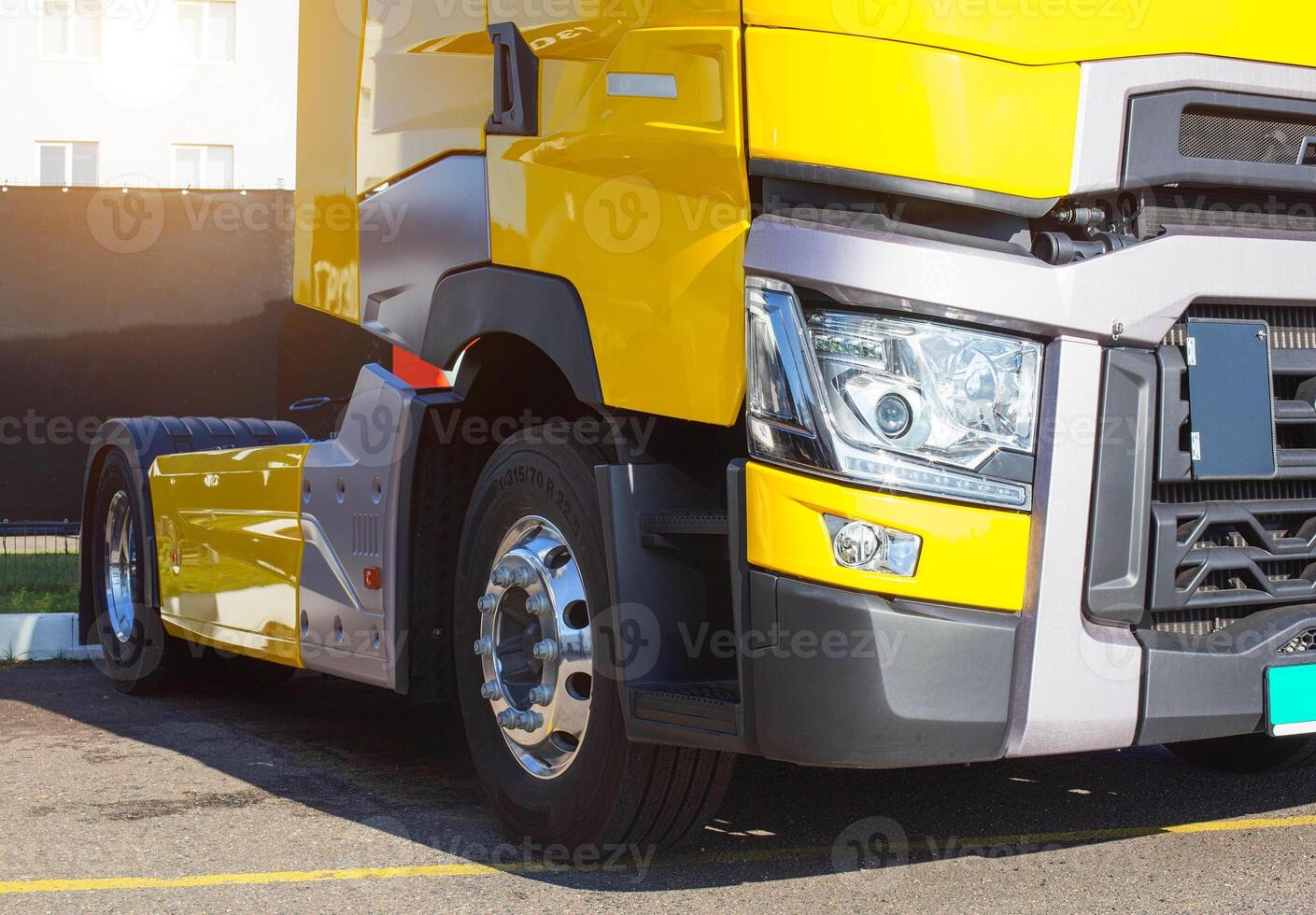 Yellow modern semi-trailer truck with modern LED headlights. Stylish and beautiful truck concept, logistic photo