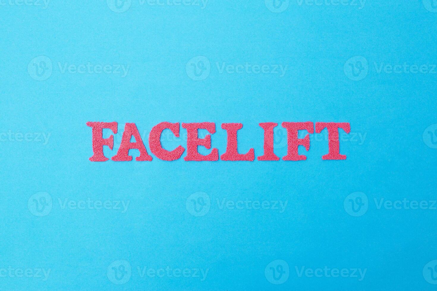 Word facelift in red letters on a blue background. Concept of modern facelift cosmetology procedure, cosmetology photo