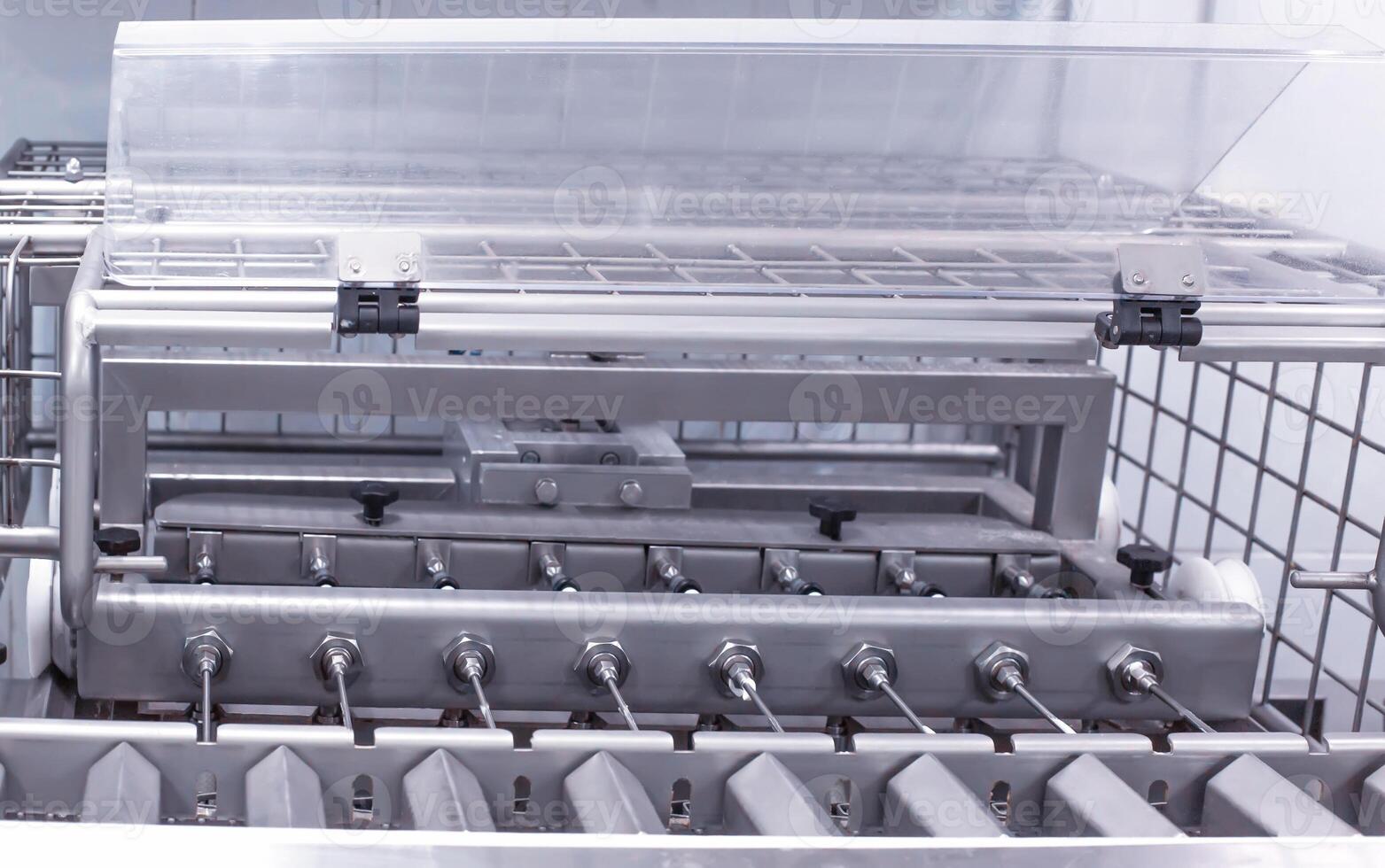 Making and filling custard cakes with cream on a modern automatic line, production of confectionery sweets photo