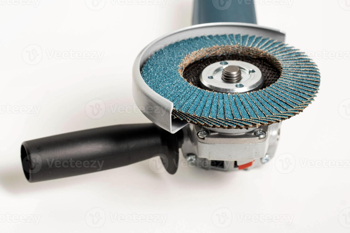 Professional angle grinder with flap wheel for processing wooden surfaces. Construction power tool. Industry, close-up photo