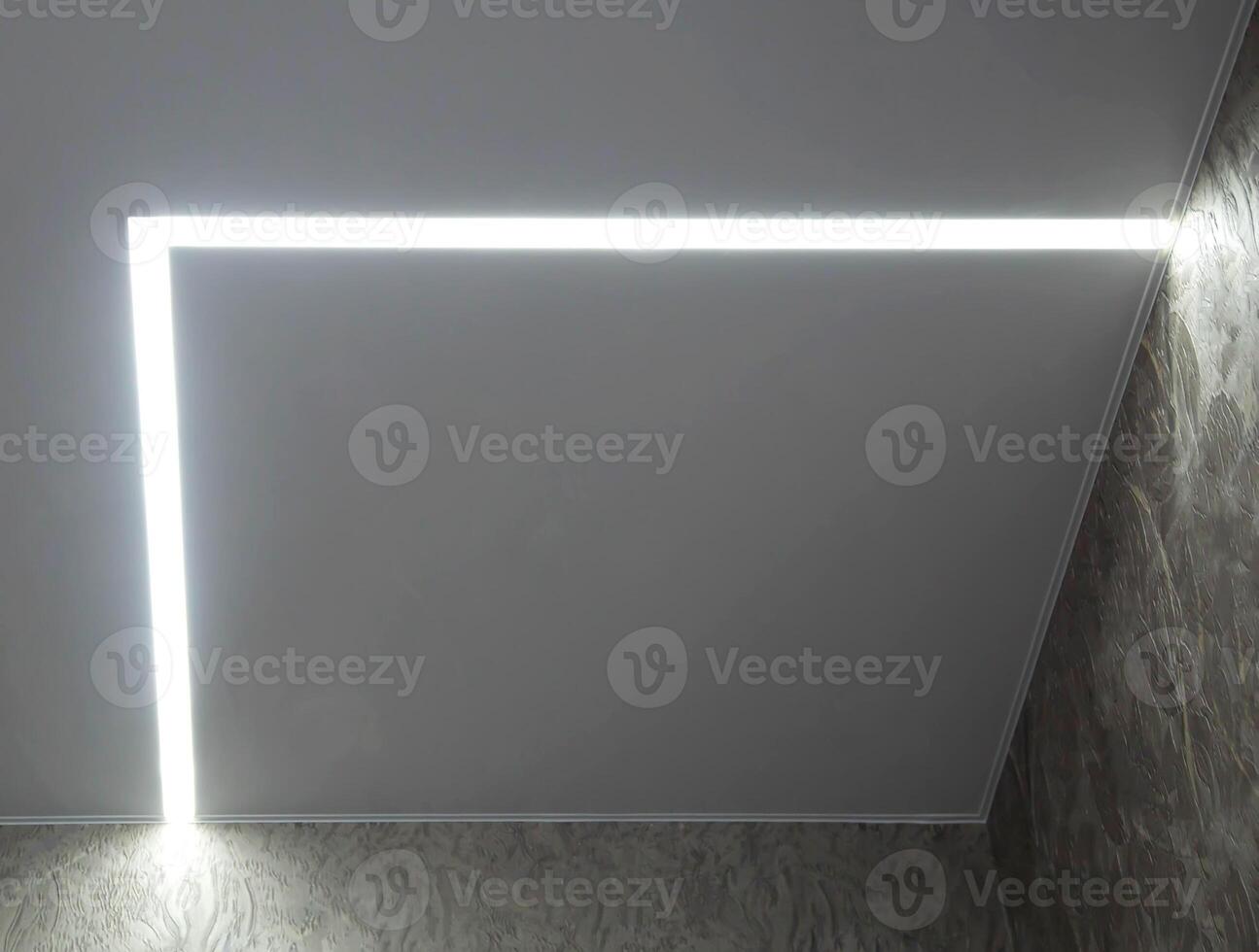Diode lighting in the corners of the ceiling in an apartment with a stretch ceiling. Modern design, close-up photo