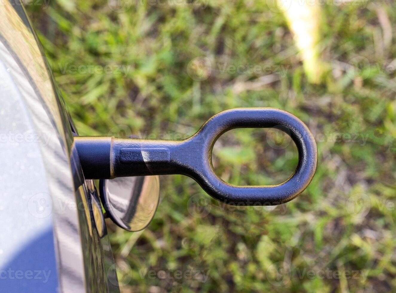 Screwed on the towing hook in a passenger car for towing a car, close-up. Transportation photo