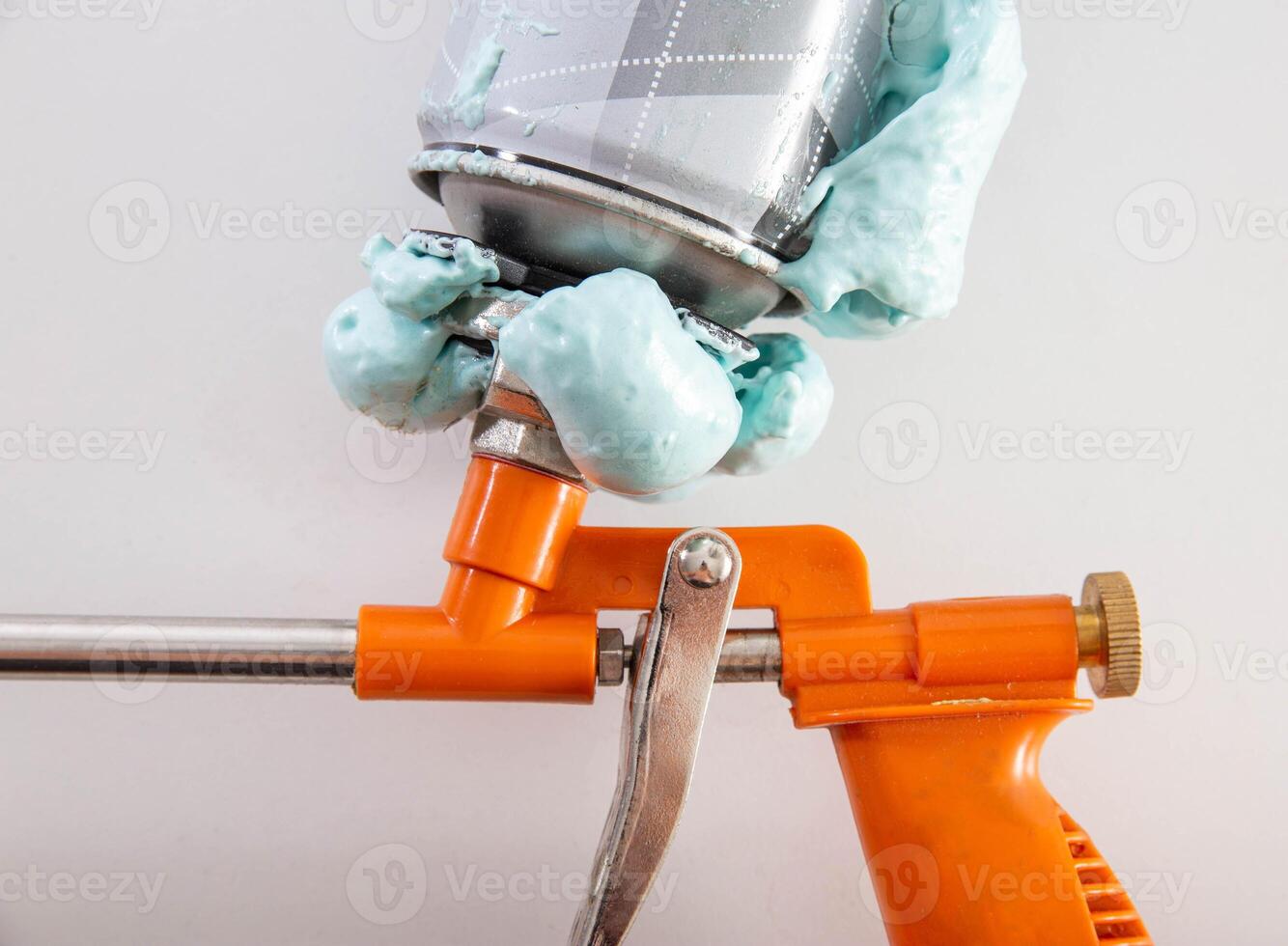 Construction foam gun with a defective cylinder. Foam bottle defect, close-up photo