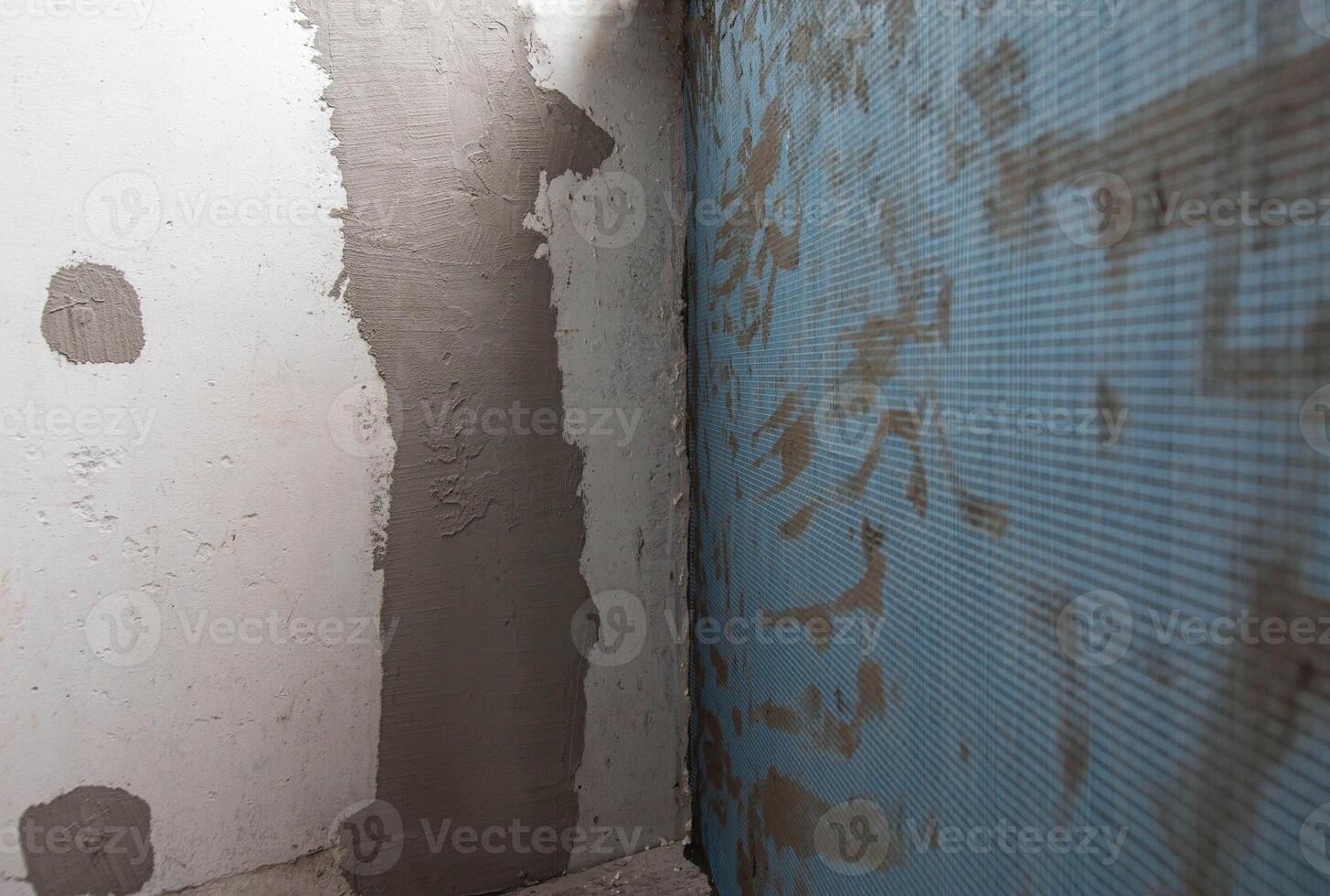 Plastered wall with reinforcing mesh, background. Building and strengthening the wall, industry photo