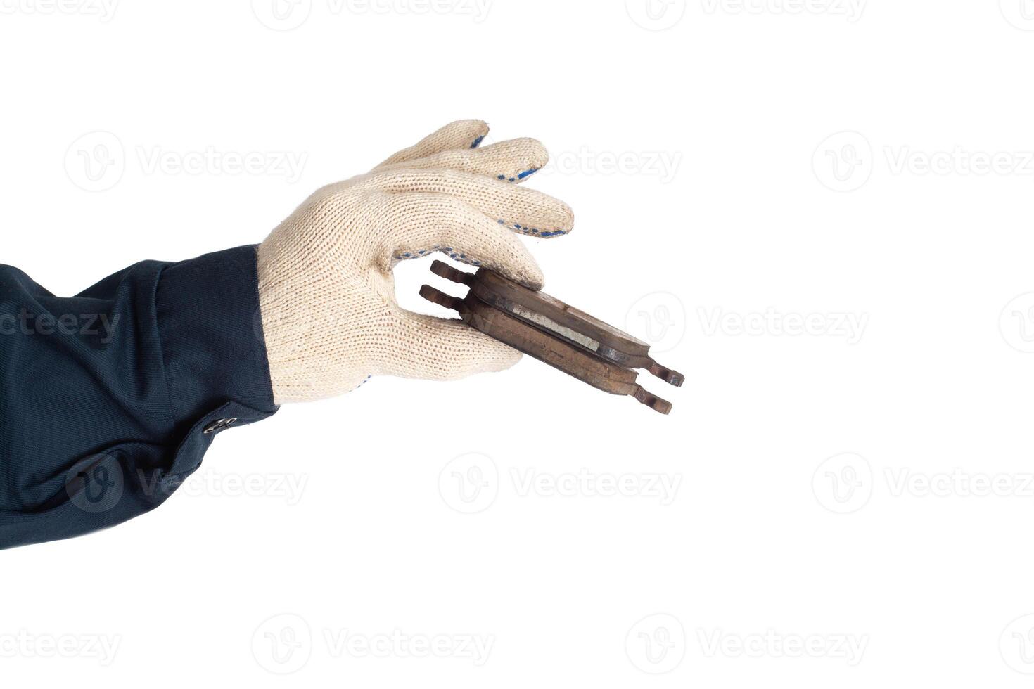 Car locksmith holds old worn out brake pads on white background, isolate. Regulations for replacing brake pads with new ones, road safety photo