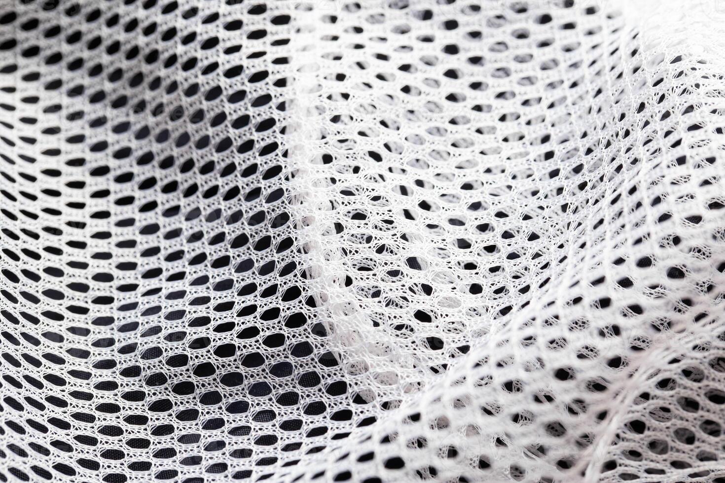 White lining in clothes in a hole, macro. Textured photo