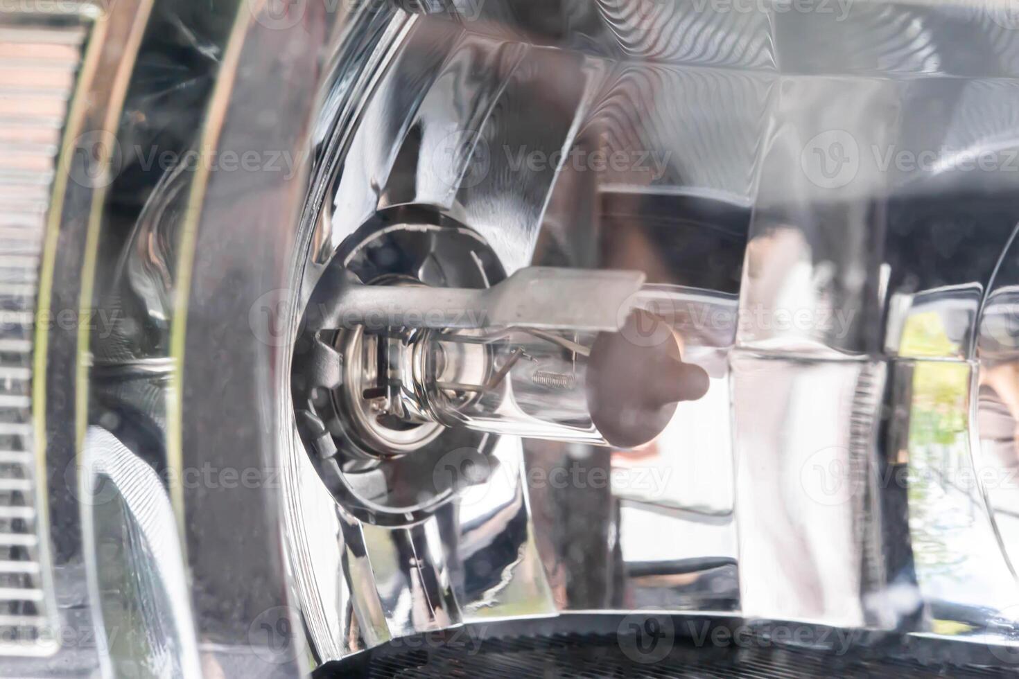 Halogen bulb in headlight with reflector of a passenger car, macro photo