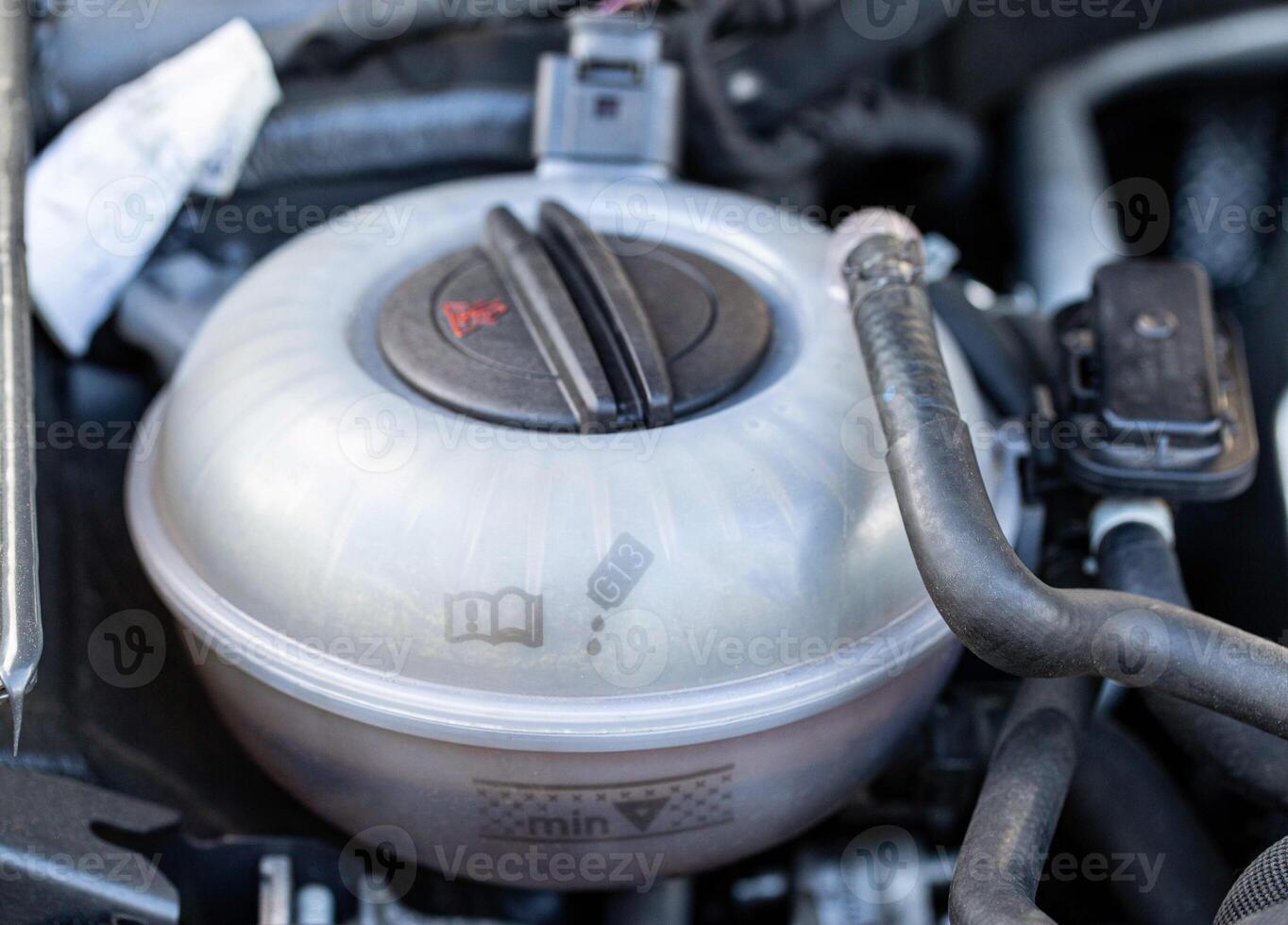 expansion tank with car coolant, close-up. Industry photo