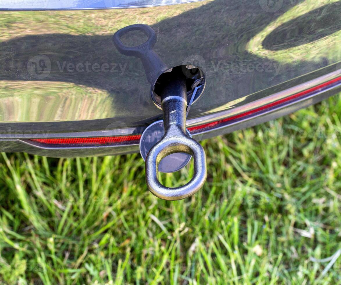 Screwed on the towing hook in a passenger car for towing a car, close-up. Transportation photo