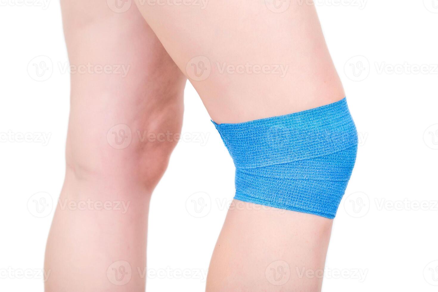 Fixation of a sore knee joint with an elastic bandage for arthrosis and sports injury. photo