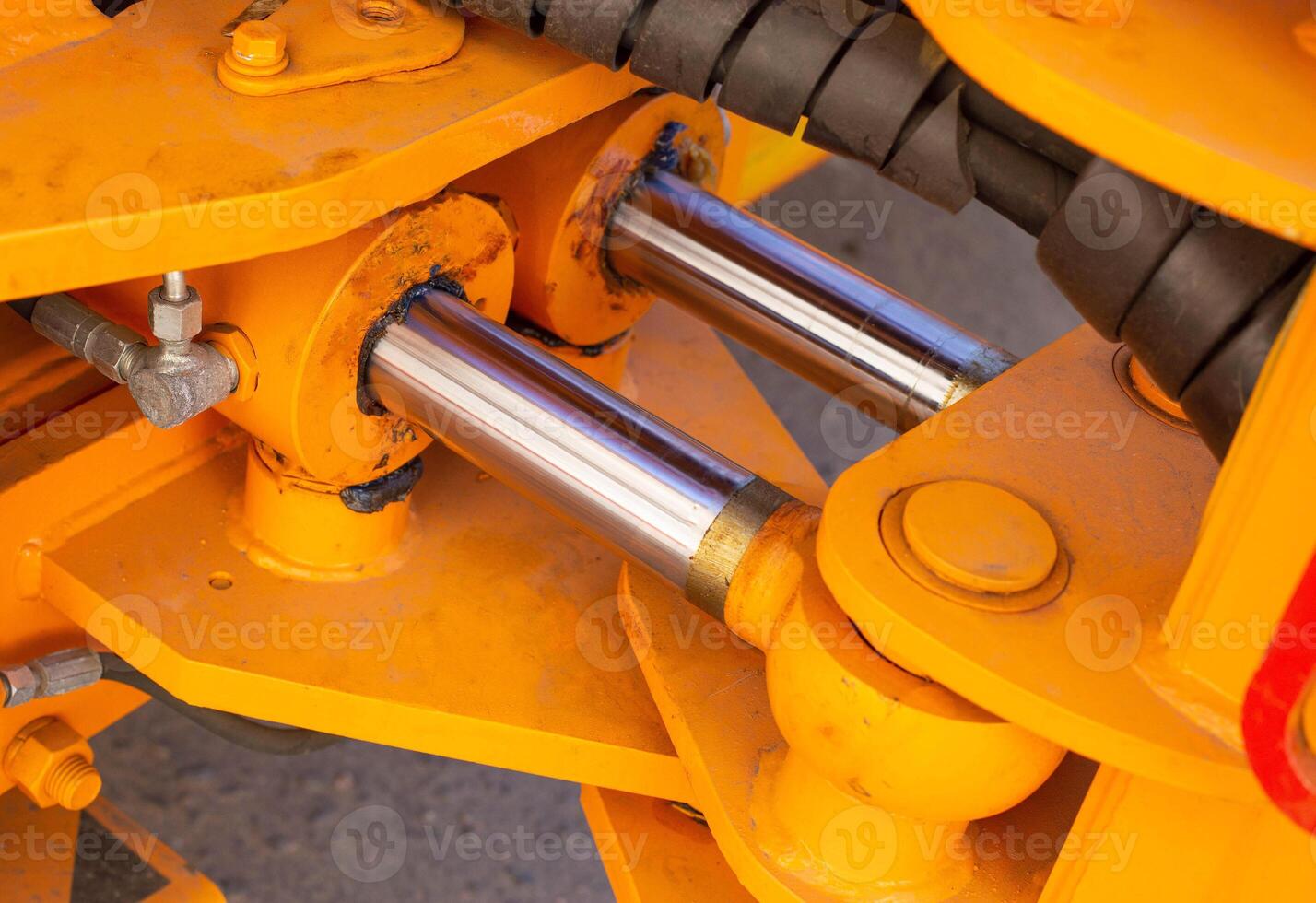 Powerful hydraulic pumps that stand in the bucket of an excavator, industry, close-up, orange photo