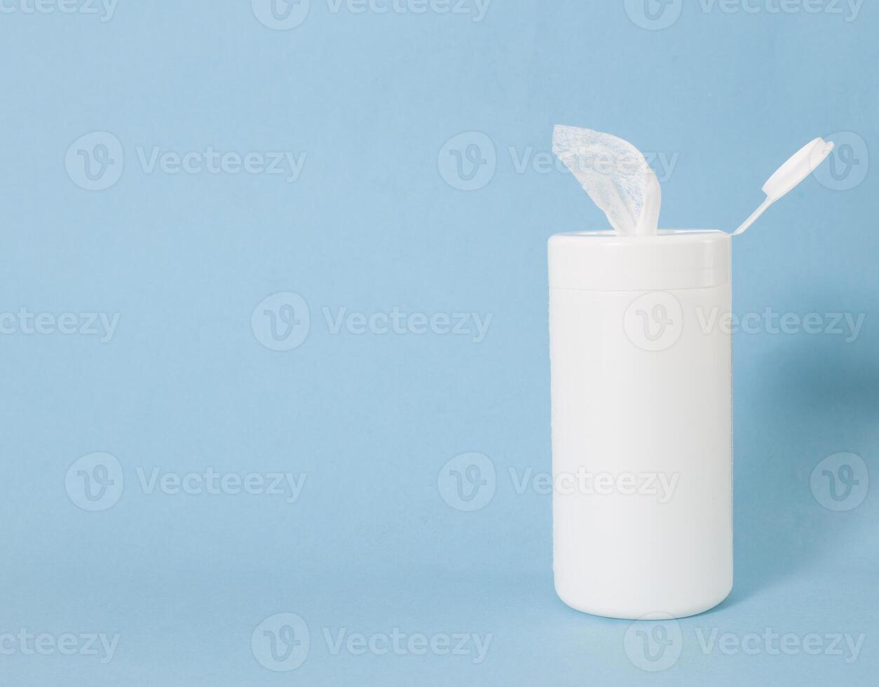 Packing of antiseptic wet wipes for disinfection and cleaning the skin of viruses and germs, blue background, copy space, bacteria photo