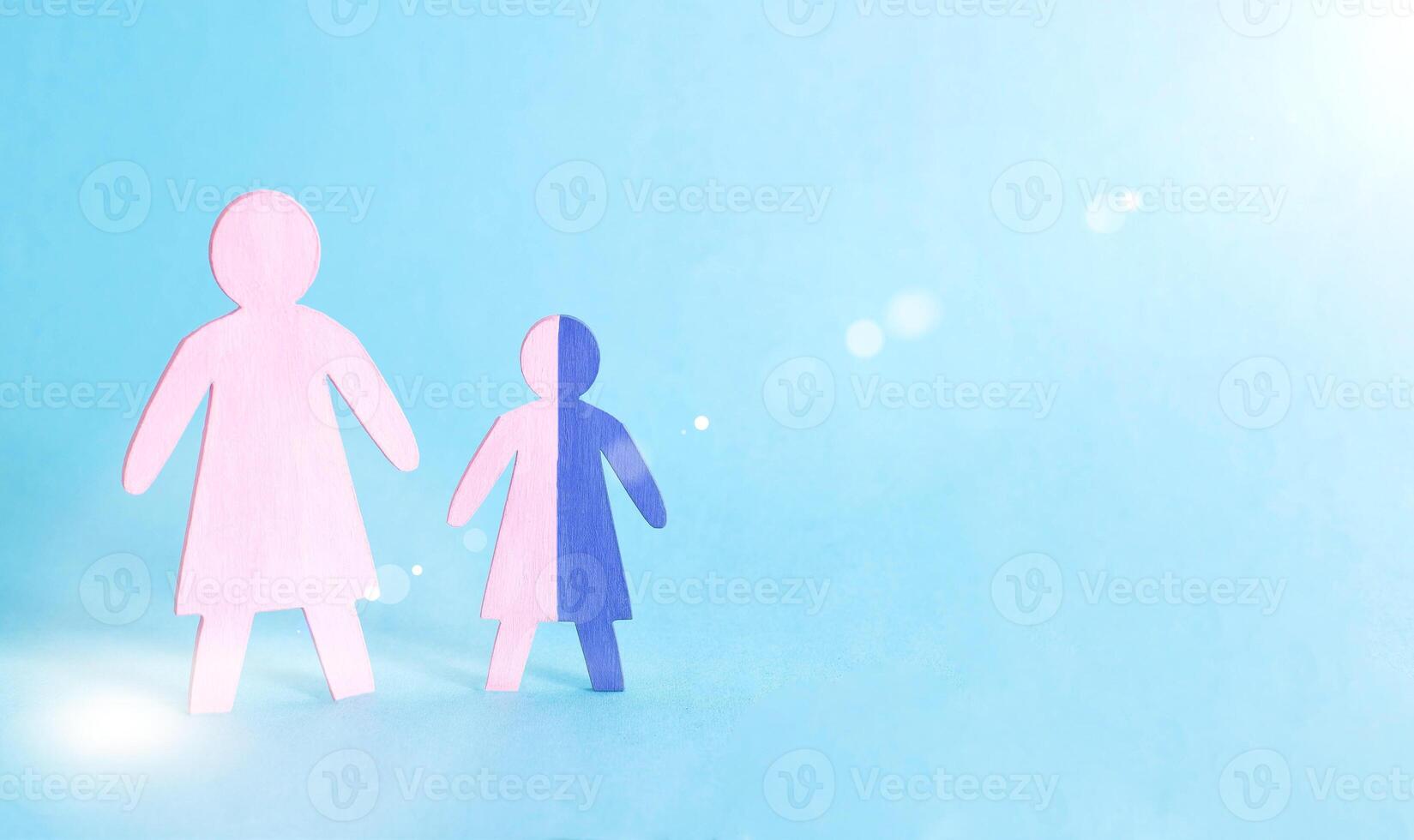 Figures of mother and baby on a blue background. Single mother concept raising a child without a father, guardianship, copy space photo