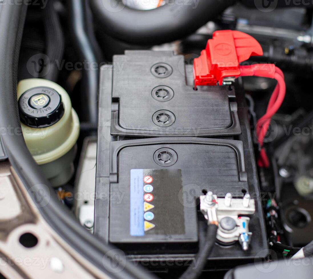 the battery in the car in the engine compartment, background, accumulator battery photo