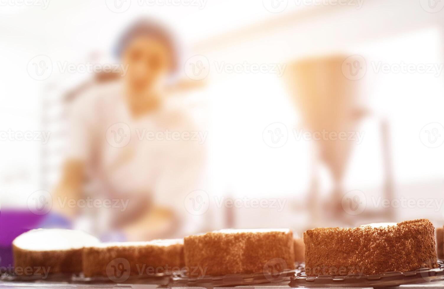 Mass production of cakes and sweets at the confectionery factory. Chefs make cakes of fresh berries and biscuit, food industry, copy space photo