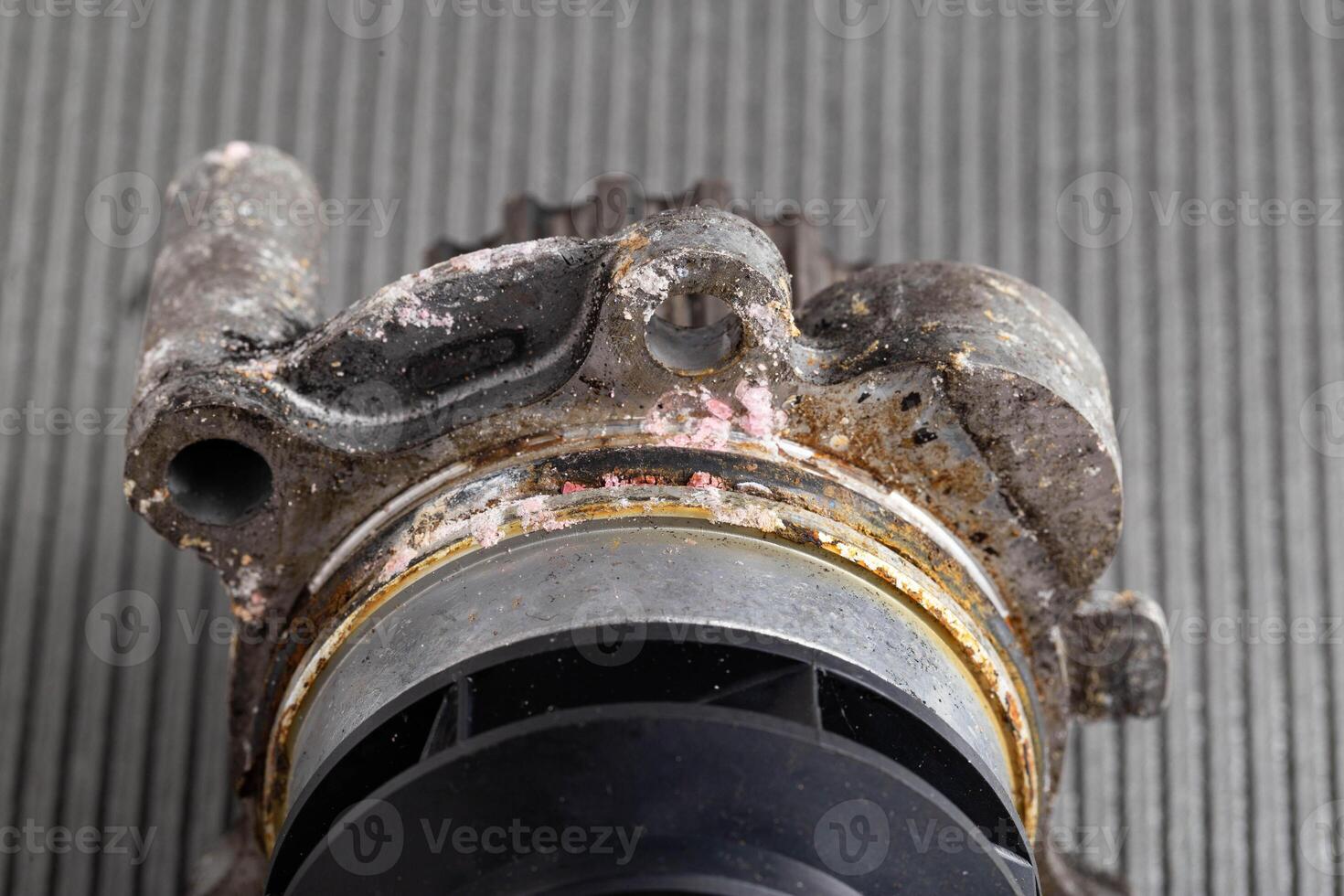 Old leaky car pump. Breakdown of the car pump in the cooling system, macro photo