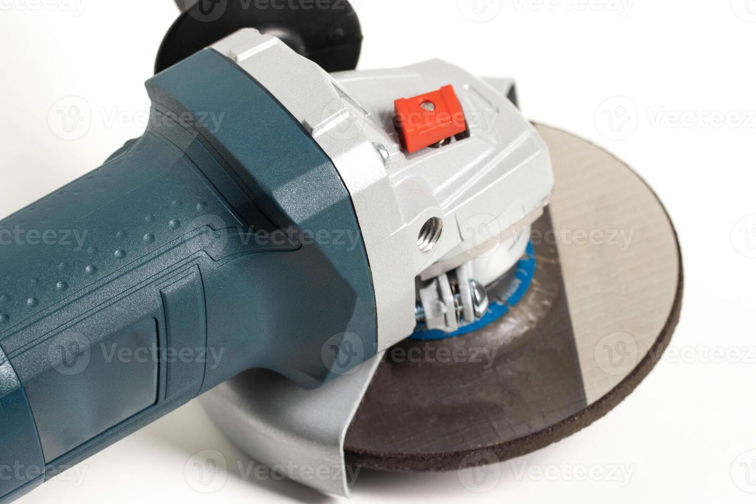 Modern angle grinder with red spindle lock button. Close-up, smooth start. photo