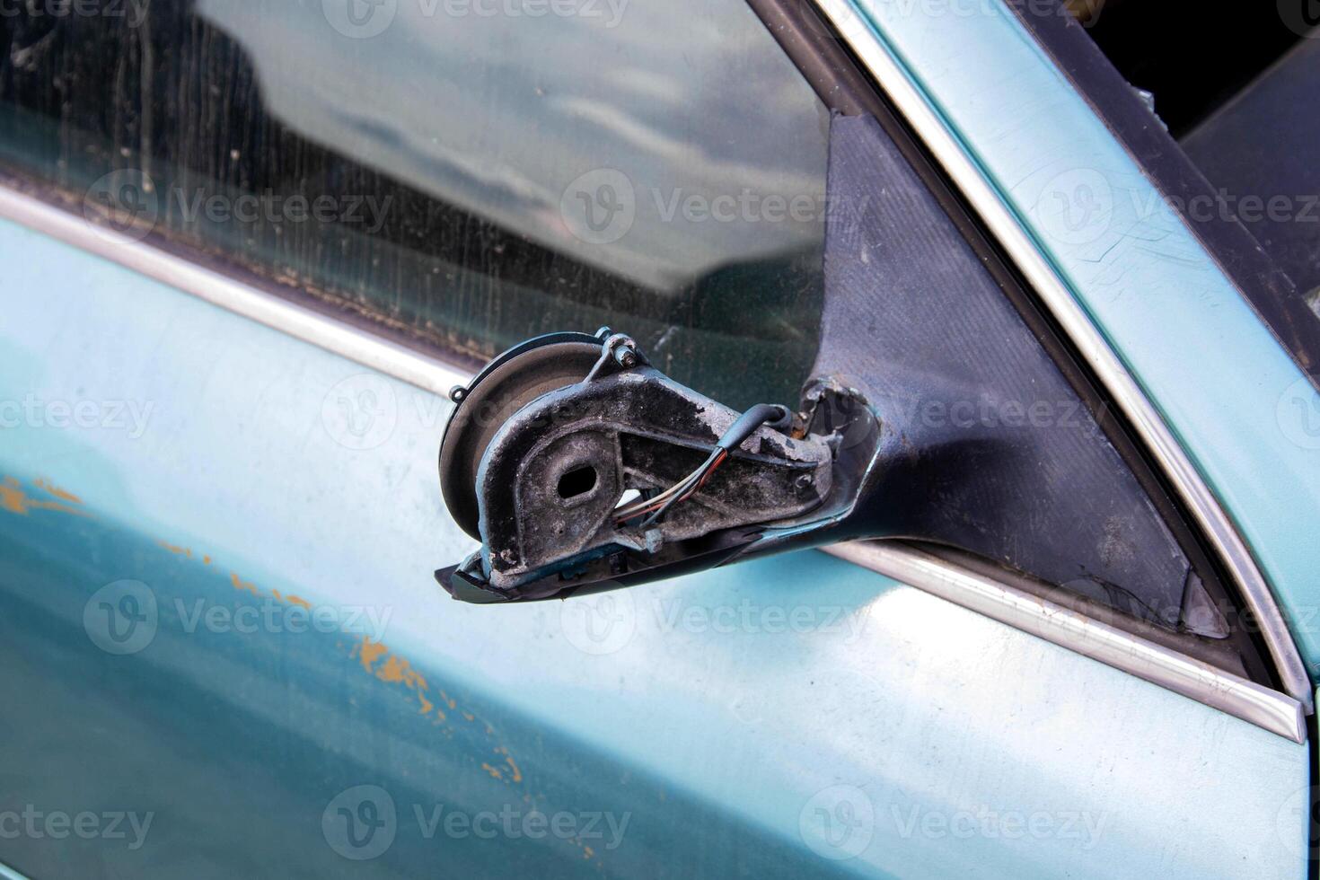 Broken car mirror on a car. Vandalism and hooliganism. Close-up photo