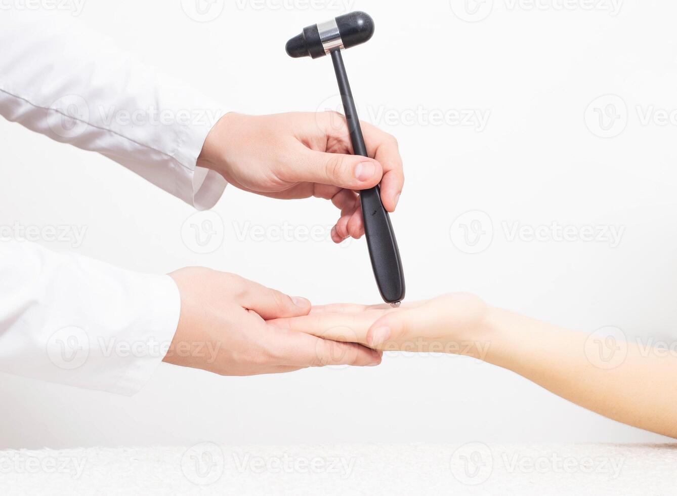 A neurologist examines a girl s palm chin reflex with a neurological hammer. Cervicocranialgia and oral automatism photo