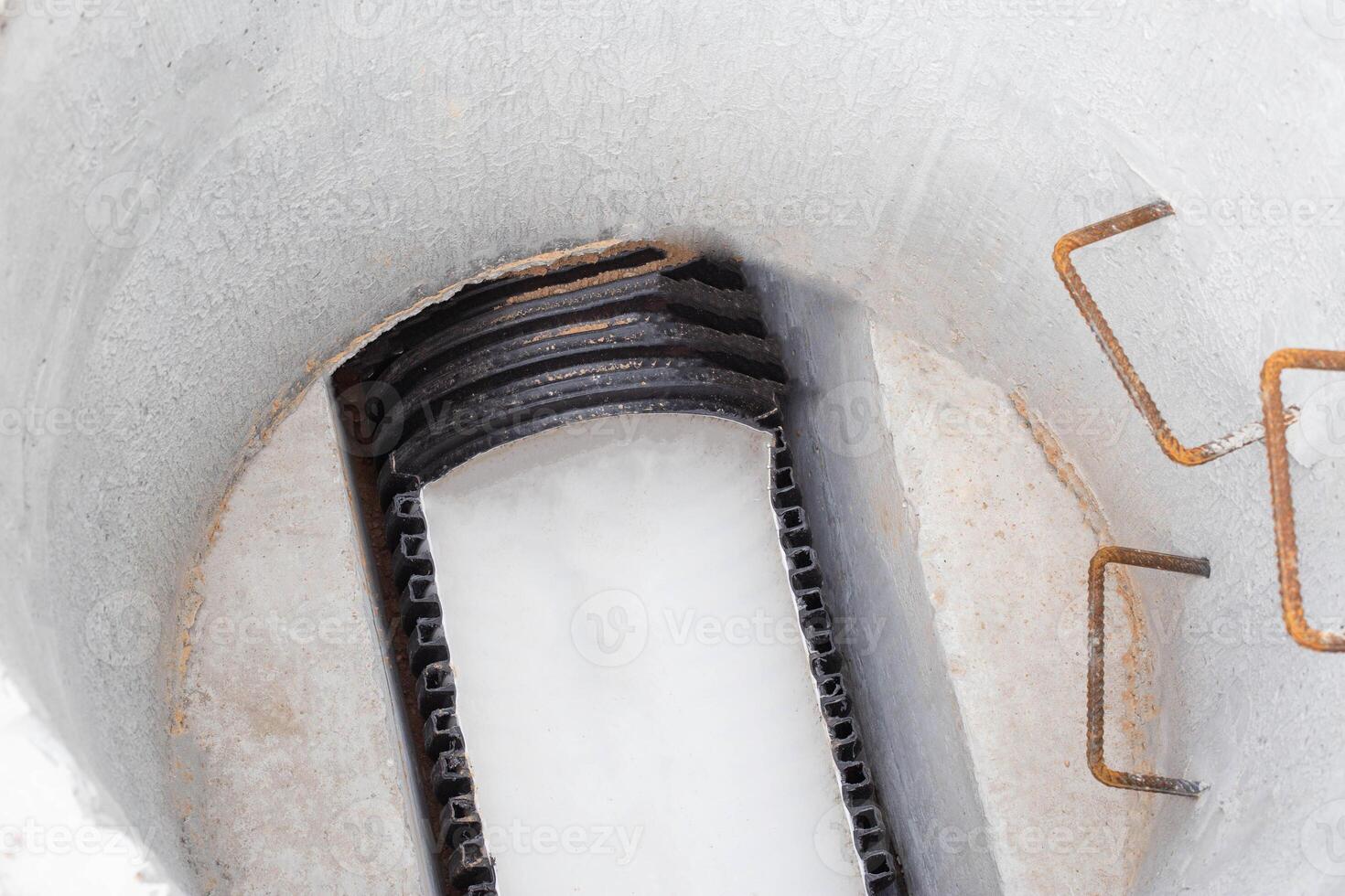 Construction of sewage engineering structures for the drain of sanitary water and rainwater, industry. Plastic pipes in the sewage system in reinforced concrete rings, sewer network photo