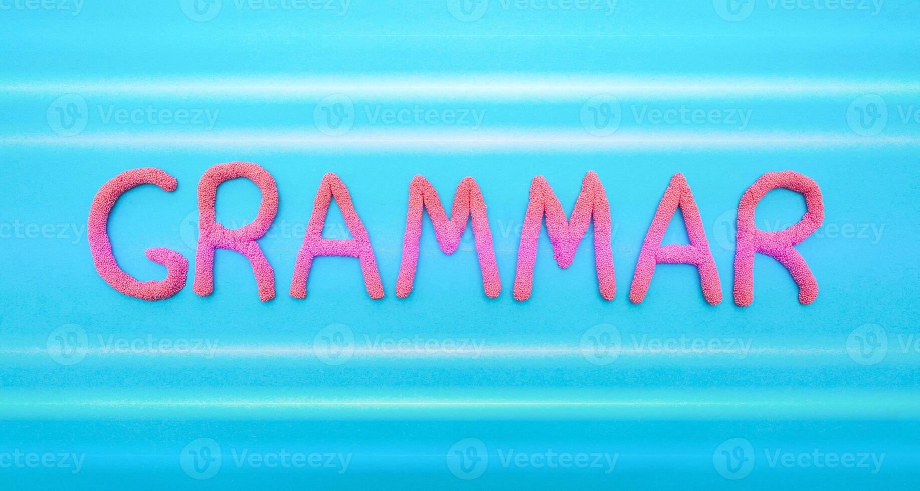 Grammar word in red letters on a blue background. Grammar and language learning concept, punctuation photo
