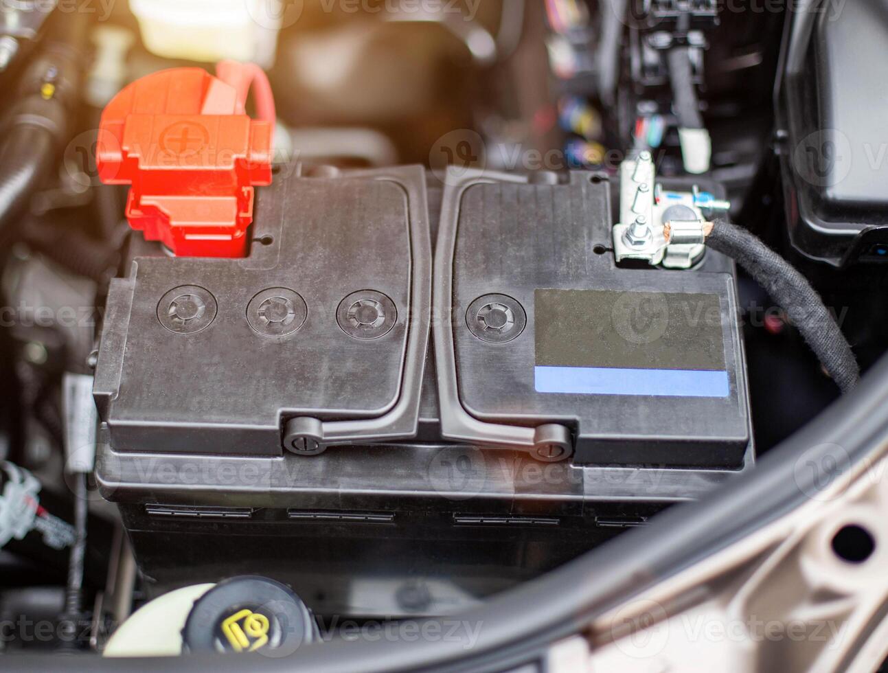 the battery in the car in the engine compartment, background, accumulator battery photo