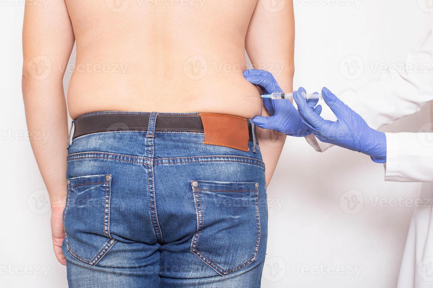 The doctor gives a subcutaneous injection to break down fat deposits on the sides of a man, lipolysis photo