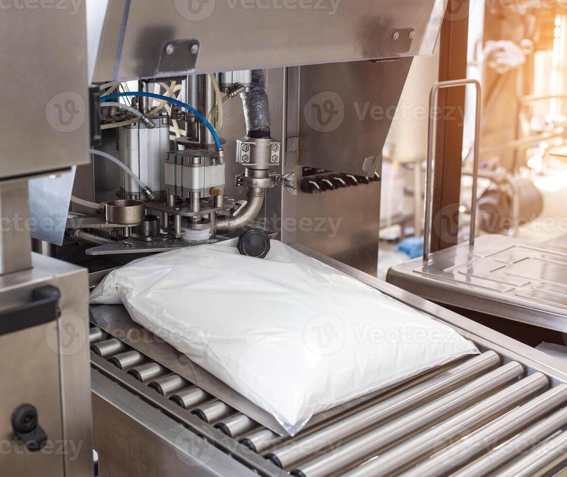 Production and manufacture of milk yogurt with bifidobacteria, technological process. Automatic line for packaging drinking yogurt photo