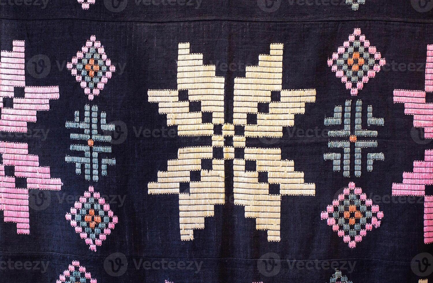 Traditional rustic tablecloth with handmade patterns and embroidery, macro photo