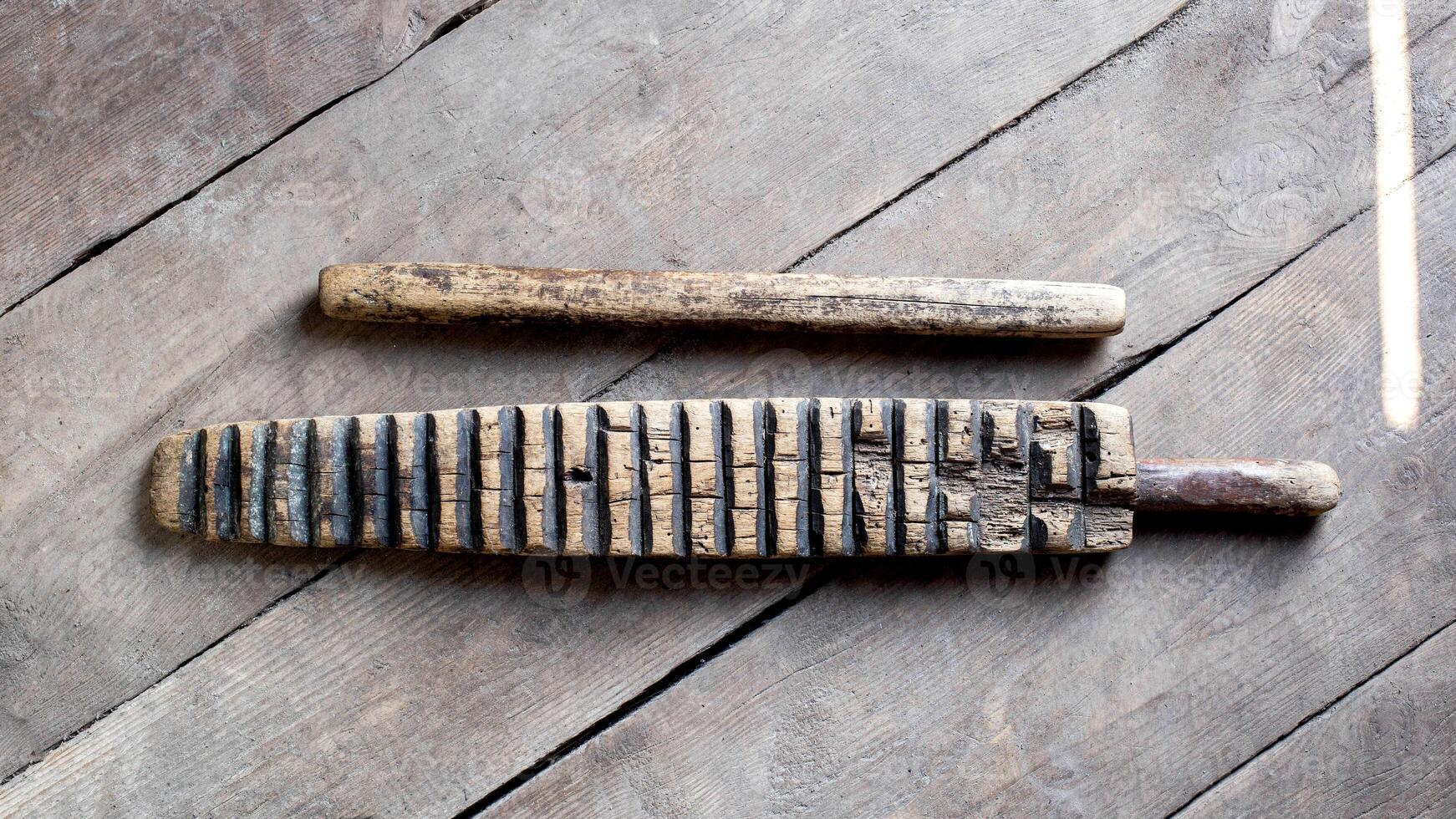 Household item was used for knocking out washing and ironing clothes. The hand-wrung linen was wound on a roller or rolling pin and rolled out with a ruber. Ancient thing photo