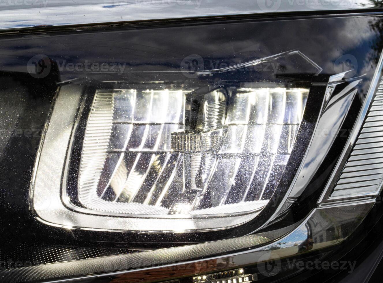 Economical and modern car headlight with LED adaptive light. Close-up, illuminate photo