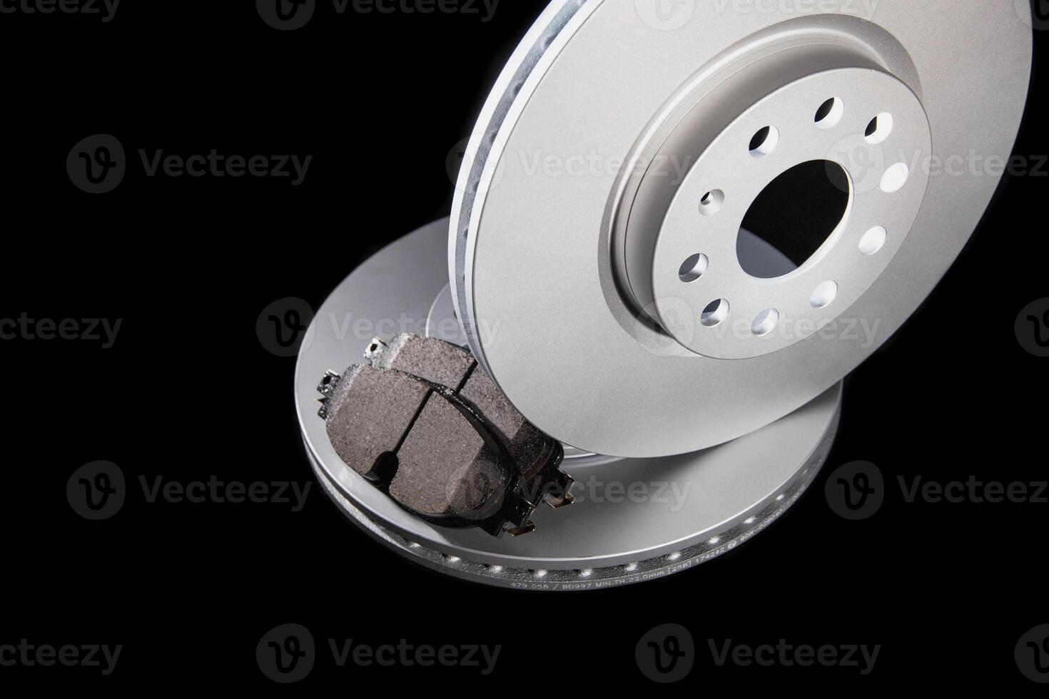 New brake pads and brake discs on a black background. Auto Parts Braking System, close-up photo