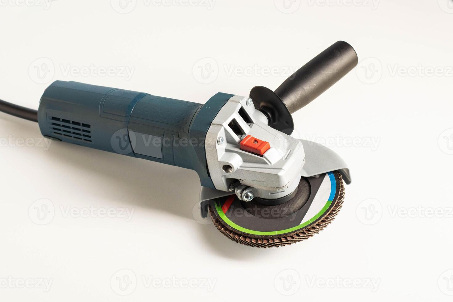 Modern professional angle grinder with a flap wheel on a white background. Power tool for work. Sanding wood and metal. photo