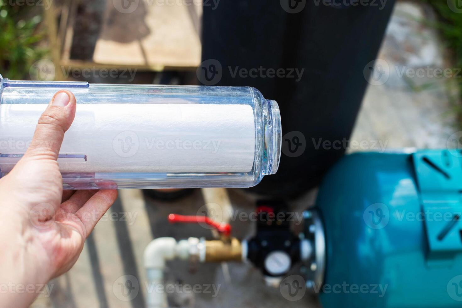 Filtration of water from a well with a sand and dirt filter. Water supply in the country. photo