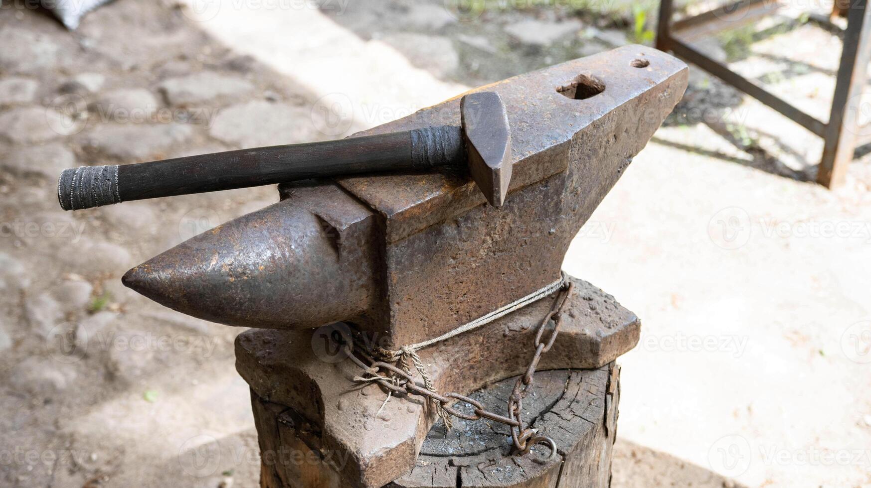 Anvil in the forge and a lot of hammers. Workshop for working with iron. industry photo