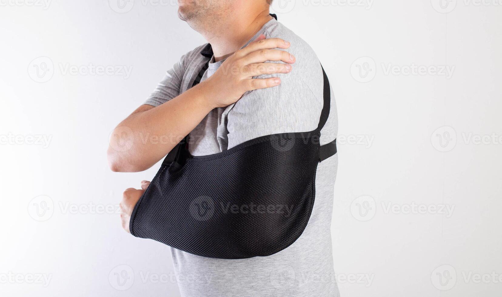 A man's arm in a black bandage for immobilization of the elbow joint after an injury. Bandage for rehabilitation after fractures of the humerus, ulna and radius. Sprain, traumatology photo