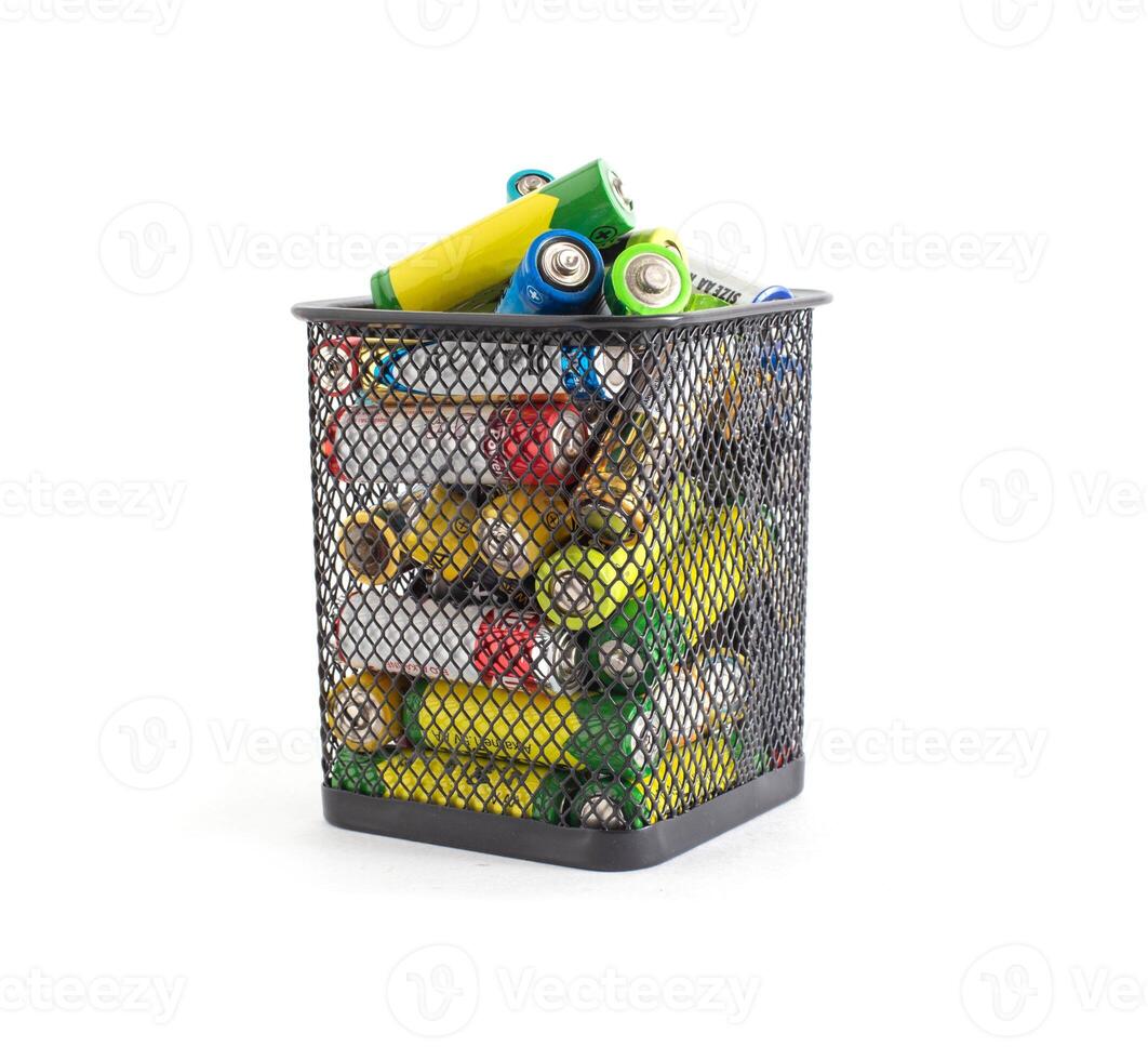 Basket with waste batteries on a white background. Battery recycling concept, business, electrical photo
